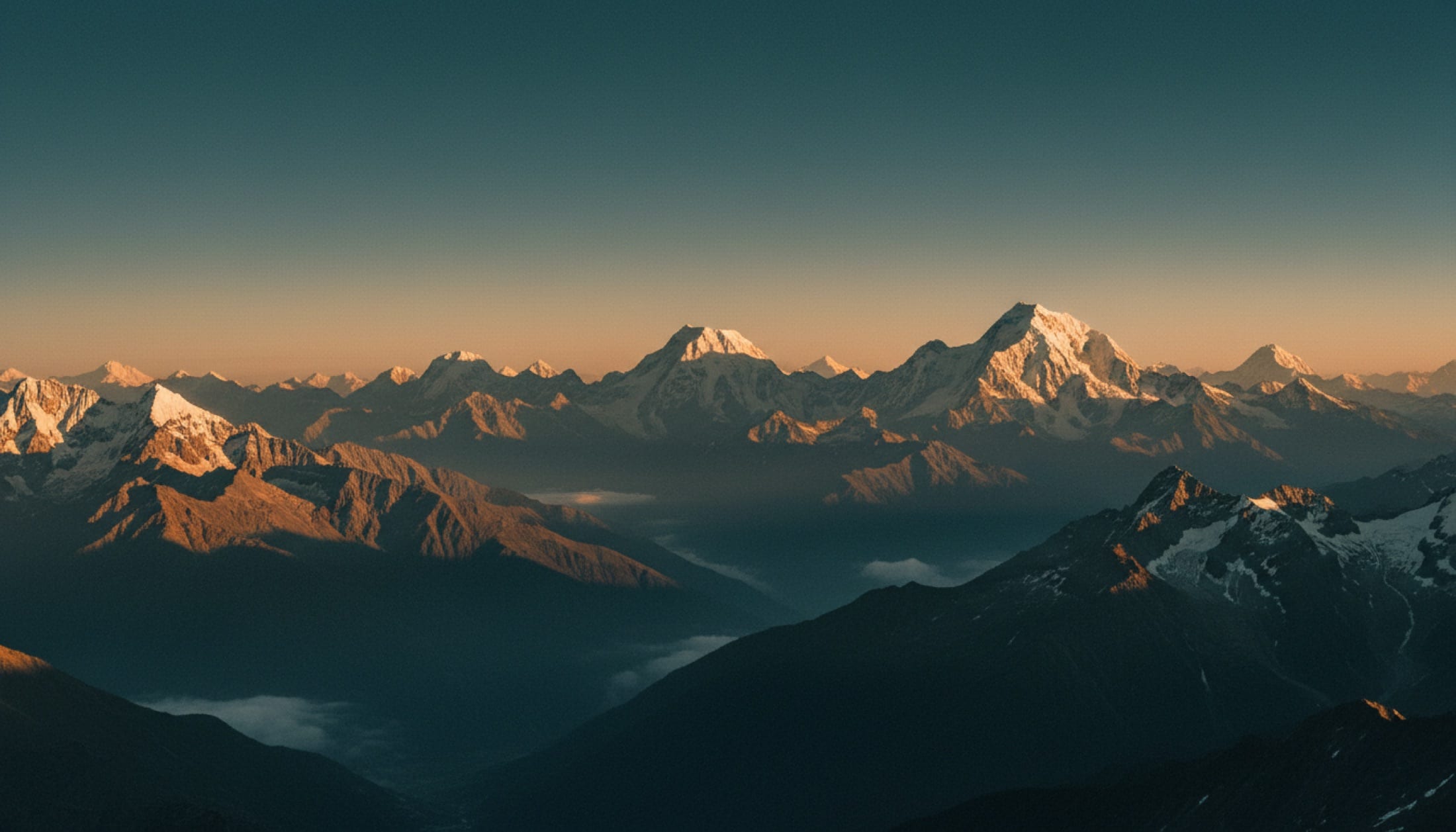 The sun setting over the Himalayas, golden light across ancient terrain